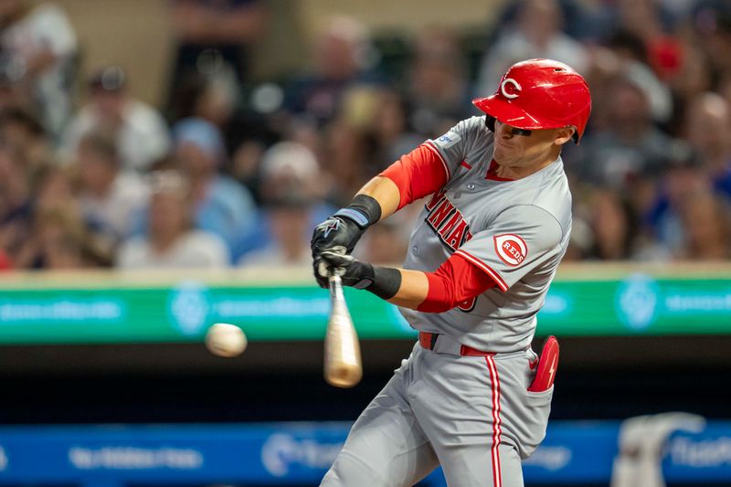 Sep 13, 2024; Minneapolis, Minnesota, USA; Cincinnati Reds center fielder TJ Friedl (29) hits an RBI single against the Minnesota Twins in the eighth inning at Target Field. Mandatory Credit: Jesse Johnson-Imagn Images