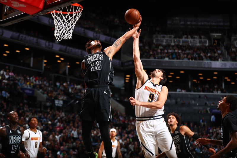 BROOKLYN, NY - OCTOBER 29: Nicolas Claxton #33 of the Brooklyn Nets goes up for the rebound during the game against the Denver Nuggets on October 29, 2024 at Barclays Center in Brooklyn, New York. NOTE TO USER: User expressly acknowledges and agrees that, by downloading and or using this Photograph, user is consenting to the terms and conditions of the Getty Images License Agreement. Mandatory Copyright Notice: Copyright 2024 NBAE (Photo by David L. Nemec/NBAE via Getty Images)