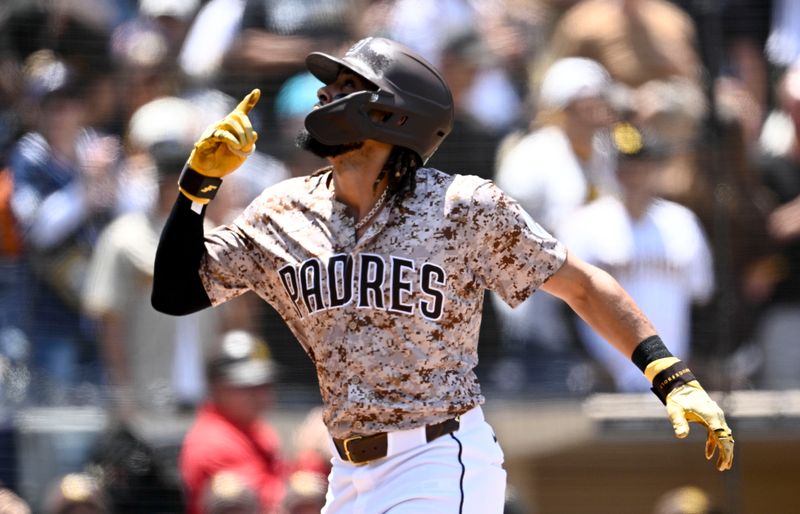 May 18, 2025; San Diego, California, USA; San Diego Padres right fielder Fernando Tatis Jr. (23) points skyward after hitting a solo home run during the first inning against the Seattle Mariners at Petco Park. Mandatory Credit: Denis Poroy-Imagn Images
