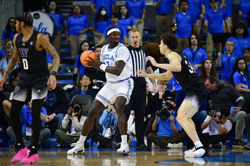 January 14, 2024; Los Angeles, California, USA; UCLA Bruins forward Adem Bona (3) moves the ball against Washington Huskies center Braxton Meah (34) during the first half at Pauley Pavilion. Mandatory Credit: Gary A. Vasquez-USA TODAY Sports