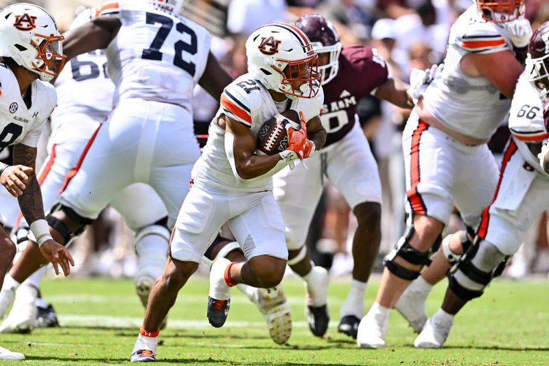 Sep 23, 2023; College Station, Texas, USA; Auburn Tigers running back Brian Battie (21) runs the ball during the fourth quarter against the Texas A&M Aggies at Kyle Field. Mandatory Credit: Maria Lysaker-USA TODAY Sports