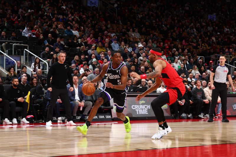 TORONTO, CANADA - MARCH 20: De'Aaron Fox #5 of the Sacramento Kings dribbles the ball during the game against the Toronto Raptors on March 20, 2024 at the Scotiabank Arena in Toronto, Ontario, Canada.  NOTE TO USER: User expressly acknowledges and agrees that, by downloading and or using this Photograph, user is consenting to the terms and conditions of the Getty Images License Agreement.  Mandatory Copyright Notice: Copyright 2024 NBAE (Photo by Vaughn Ridley/NBAE via Getty Images)