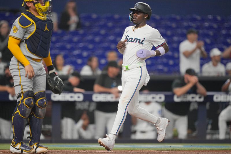 May 21, 2024; Miami, Florida, USA; Miami Marlins center fielder Jazz Chisholm Jr. (2) scores a run in the second inning against the Milwaukee Brewers at loanDepot Park. Mandatory Credit: Jim Rassol-USA TODAY Sports