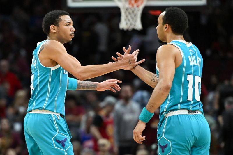 CLEVELAND, OHIO - APRIL 14: Nick Smith Jr. #8 and Amari Bailey #10 of the Charlotte Hornets celebrate the team's 120-110 win over the Cleveland Cavaliers at Rocket Mortgage Fieldhouse on April 14, 2024 in Cleveland, Ohio. NOTE TO USER: User expressly acknowledges and agrees that, by downloading and or using this photograph, User is consenting to the terms and conditions of the Getty Images License Agreement. (Photo by Nick Cammett/Getty Images)