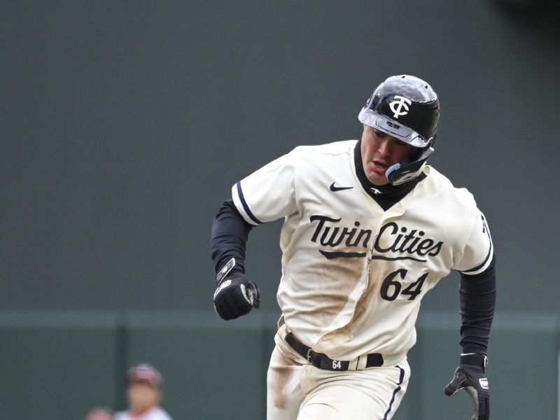 Apr 23, 2023; Minneapolis, Minnesota, USA;  Minnesota Twins infielder Jose Miranda (64) runs the bases against the Washington Nationals on a single by catcher Ryan Jeffers (27) during the seventh inning at Target Field. Mandatory Credit: Nick Wosika-USA TODAY Sports