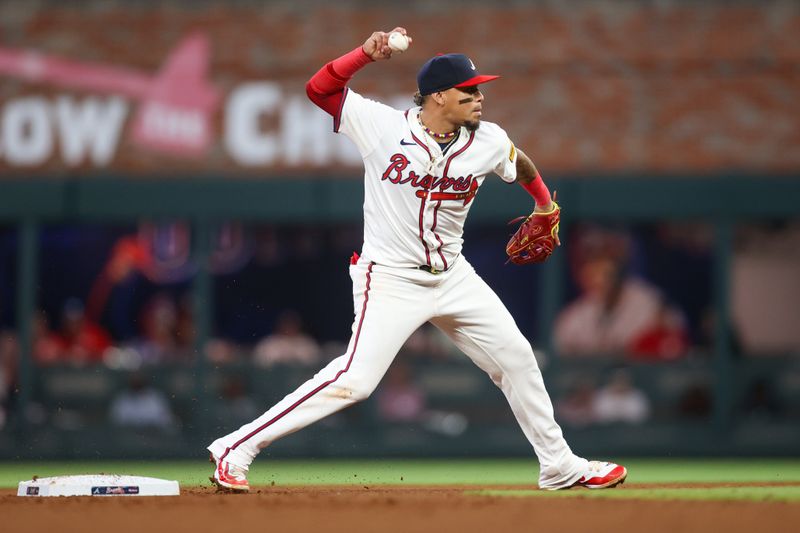 Apr 24, 2024; Atlanta, Georgia, USA; Atlanta Braves shortstop Orlando Arcia (11) throws a runner out at first against the Miami Marlins in the fourth inning at Truist Park. Mandatory Credit: Brett Davis-USA TODAY Sports