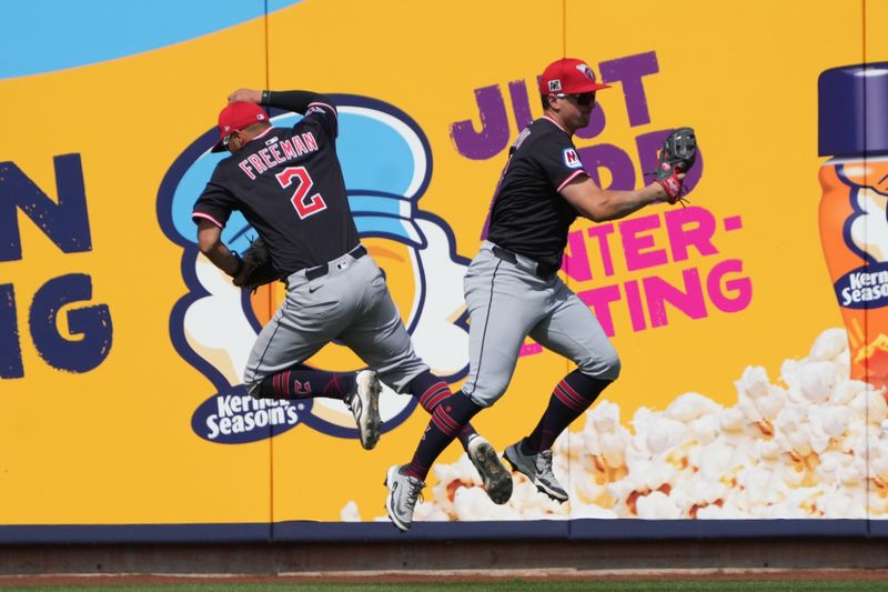 Mar 16, 2025; Phoenix, Arizona, USA; Cleveland Guardians outfielder Will Brennan (17) makes the catch for an out while avoiding Tyler Freeman (2) on a ball hit by Milwaukee Brewers outfielder Christian Yelich (22) in the third inning at American Family Fields of Phoenix. Mandatory Credit: Rick Scuteri-Imagn Images