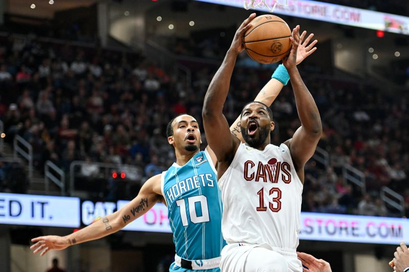 CLEVELAND, OHIO - APRIL 14: Tristan Thompson #13 of the Cleveland Cavaliers shoots against Amari Bailey #10 of the Charlotte Hornets during the first half at Rocket Mortgage Fieldhouse on April 14, 2024 in Cleveland, Ohio. NOTE TO USER: User expressly acknowledges and agrees that, by downloading and or using this photograph, User is consenting to the terms and conditions of the Getty Images License Agreement. (Photo by Nick Cammett/Getty Images)