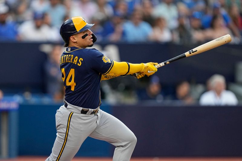 May 30, 2023; Toronto, Ontario, CAN; Milwaukee Brewers catcher William Contreras (24) hits a two run home run during the first inning against the Toronto Blue Jays at Rogers Centre. Mandatory Credit: John E. Sokolowski-USA TODAY Sports