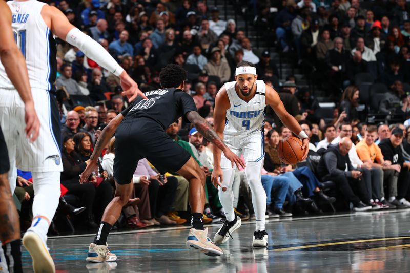 BROOKLYN, NY - NOVEMBER 29: Jalen Suggs #4 of the Orlando Magic dribbles the ball during the game against the Brooklyn Nets during a Emirates NBA Cup game on October 22, 2024 at Barclays Center in Brooklyn, New York. NOTE TO USER: User expressly acknowledges and agrees that, by downloading and or using this Photograph, user is consenting to the terms and conditions of the Getty Images License Agreement. Mandatory Copyright Notice: Copyright 2024 NBAE (Photo by David L. Nemec/NBAE via Getty Images)