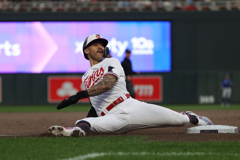 Oct 4, 2023; Minneapolis, Minnesota, USA; Minnesota Twins shortstop Carlos Correa (4) slides into third base in the eighth inning against the Toronto Blue Jays during game two of the Wildcard series for the 2023 MLB playoffs at Target Field. Mandatory Credit: Jesse Johnson-USA TODAY Sports