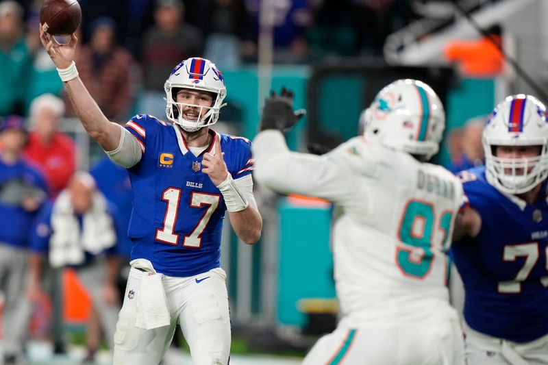 Buffalo Bills quarterback Josh Allen (17) passes under pressure from Miami Dolphins defensive end Emmanuel Ogbah (91), during the second half of an NFL football game, Sunday, Jan. 7, 2024, in Miami Gardens, Fla. (AP Photo/Wilfredo Lee)