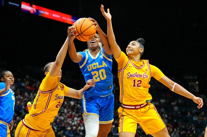 Mar 8, 2024; Las Vegas, NV, USA; UCLA Bruins guard Charisma Osborne (20) battles against USC Trojans forward Kaitlyn Davis (24) and USC Trojans guard JuJu Watkins (12) for control of a rebound during the third quarter at MGM Grand Garden Arena. Mandatory Credit: Stephen R. Sylvanie-USA TODAY Sports