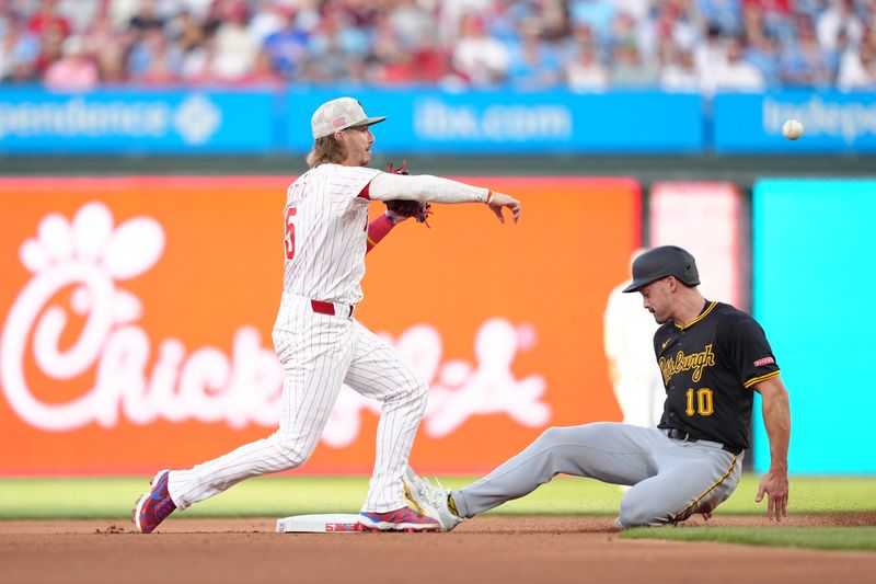 May 17, 2025; Philadelphia, Pennsylvania, USA; Philadelphia Phillies infielder Bryson Stott (5) turns a double play over Pittsburgh Pirates outfielder Bryan Reynolds (10) in the fourth inning at Citizens Bank Park. Mandatory Credit: Kyle Ross-Imagn Images