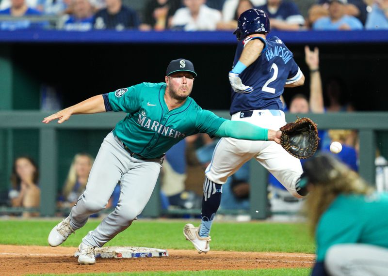 Jun 7, 2024; Kansas City, Missouri, USA; Kansas City Royals center fielder Garrett Hampson (2) reaches on an infield single as Seattle Mariners first baseman Ty France (23) is unable to make the catch during the ninth inning at Kauffman Stadium. Mandatory Credit: Jay Biggerstaff-USA TODAY Sports