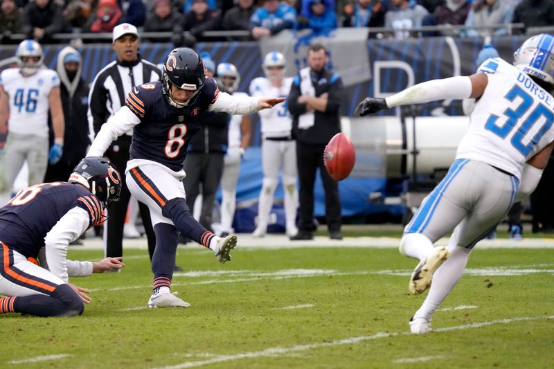 Chicago Bears place kicker Cairo Santos kicks a field goal off the hold of Trenton Gill, as Detroit Lions' Khalil Dorsey watches during the second half of an NFL football game Sunday, Dec. 10, 2023, in Chicago. (AP Photo/Nam Y. Huh)