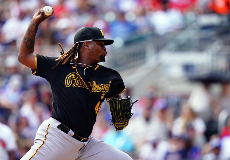 Sep 10, 2023; Cumberland, Georgia, USA; Pittsburgh Pirates starting pitcher Luis Ortiz (48) fires off a pitch against the Atlanta Braves during the sixth inning at Truist Park. Mandatory Credit: John David Mercer-USA TODAY Sports