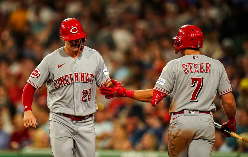 Jun 1, 2023; Boston, Massachusetts, USA; Cincinnati Reds shortstop Kevin Newman (28) is congratulated by third baseman Spencer Steer (7) after scoring against the Boston Red Sox in the eighth inning at Fenway Park. Mandatory Credit: David Butler II-USA TODAY Sports