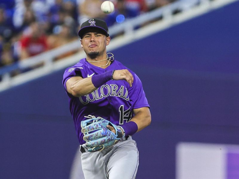 Jul 22, 2023; Miami, Florida, USA; Colorado Rockies shortstop Ezequiel Tovar (14) throws the ball to first baseman Michael Toglia (not pictured) during the eighth inning at loanDepot Park. Mandatory Credit: Sam Navarro-USA TODAY Sports