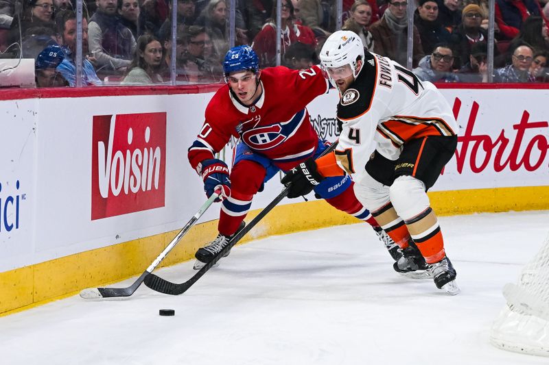 Feb 13, 2024; Montreal, Quebec, CAN; Anaheim Ducks defenseman Cam Fowler (4) defends the puck against Montreal Canadiens left wing Juraj Slafkovsky (20) during the second period at Bell Centre. Mandatory Credit: David Kirouac-USA TODAY Sports