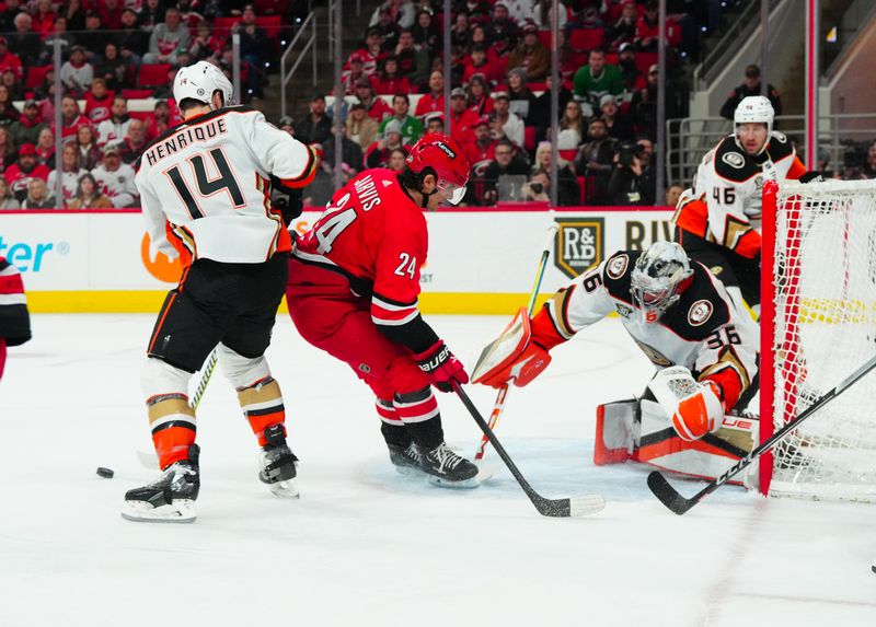 Jan 11, 2024; Raleigh, North Carolina, USA; Anaheim Ducks goaltender John Gibson (36) makes a save on Carolina Hurricanes center Seth Jarvis (24) shot during the first period at PNC Arena. Mandatory Credit: James Guillory-USA TODAY Sports