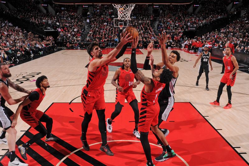 PORTLAND, OR - DECEMBER 13: Deni Avdija #8 and Anfernee Simons #1 of the Portland Trail Blazers grabs the rebound during the game against the San Antonio Spurs on December 13, 2024 at the Moda Center Arena in Portland, Oregon. NOTE TO USER: User expressly acknowledges and agrees that, by downloading and or using this photograph, user is consenting to the terms and conditions of the Getty Images License Agreement. Mandatory Copyright Notice: Copyright 2024 NBAE (Photo by Cameron Browne/NBAE via Getty Images)
