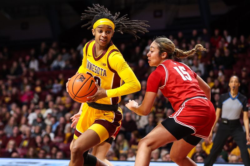 Feb 20, 2024; Minneapolis, Minnesota, USA; Minnesota Golden Gophers guard Janay Sanders (30) works around Wisconsin Badgers guard Sania Copeland (15) during the first half at Williams Arena. Mandatory Credit: Matt Krohn-USA TODAY Sports