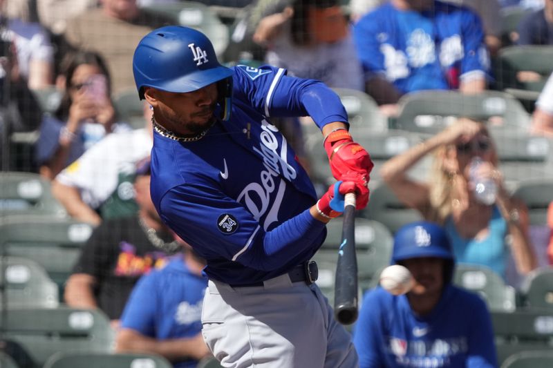 Feb 27, 2025; Salt River Pima-Maricopa, Arizona, USA; Los Angeles Dodgers shortstop Mookie Betts (50) hits against the Colorado Rockies during the first inning at Salt River Fields at Talking Stick. Mandatory Credit: Rick Scuteri-Imagn Images