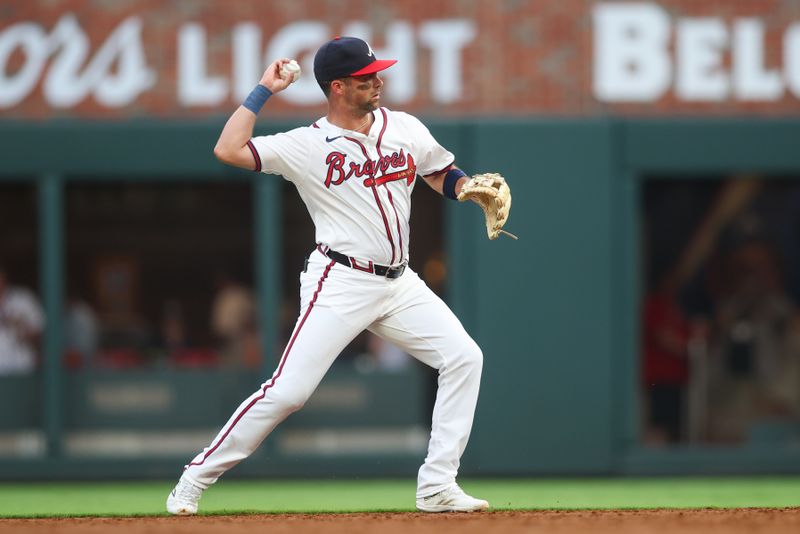 Aug 1, 2024; Atlanta, Georgia, USA; Atlanta Braves second baseman Whit Merrifield (15) throws a runner out at first against the Miami Marlins in the third inning at Truist Park. Mandatory Credit: Brett Davis-USA TODAY Sports
