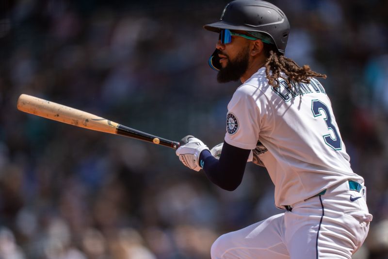 Apr 9, 2025; Seattle, Washington, USA;  Seattle Mariners shortstop J.P. Crawford (3) hits a double during the third inning against the Houston Astros at T-Mobile Park. Mandatory Credit: Stephen Brashear-Imagn Images