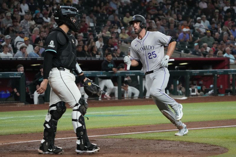 Aug 14, 2024; Phoenix, Arizona, USA; Colorado Rockies catcher Jacob Stallings (25) scores a run against the Arizona Diamondbacks in the sixth inning at Chase Field. Mandatory Credit: Rick Scuteri-USA TODAY Sports