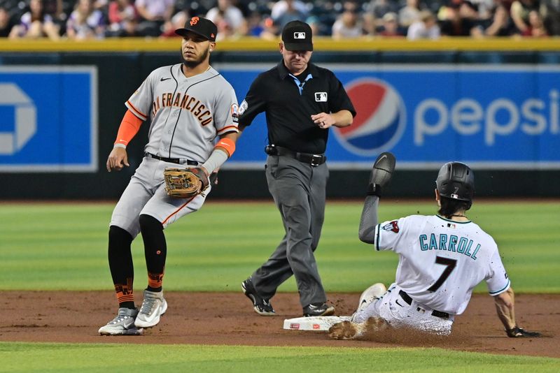 Sep 20, 2023; Phoenix, Arizona, USA;  Arizona Diamondbacks left fielder Corbin Carroll (7) steals second base against San Francisco Giants second baseman Thairo Estrada (39) in the first inning at Chase Field. Mandatory Credit: Matt Kartozian-USA TODAY Sports