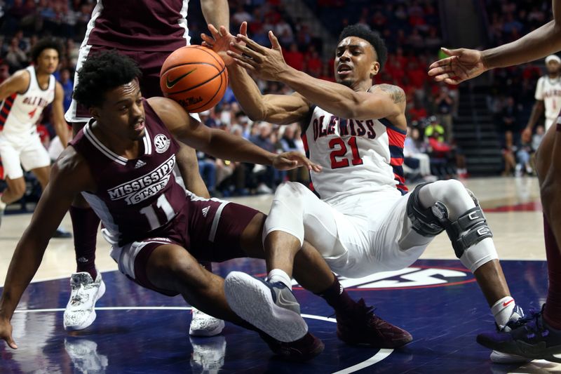 Feb 18, 2023; Oxford, Mississippi, USA; Mississippi State Bulldogs guard Eric Reed Jr. (left) and Mississippi Rebels forward Robert Allen (21) battle for a rebound during the second half at The Sandy and John Black Pavilion at Ole Miss. Mandatory Credit: Petre Thomas-USA TODAY Sports