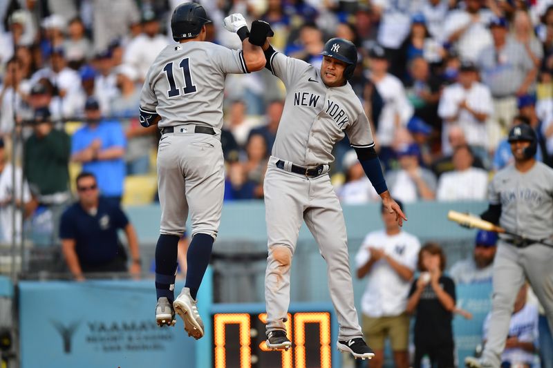 Jun 4, 2023; Los Angeles, California, USA; New York Yankees shortstop Anthony Volpe (11) is greeted by center fielder Isiah Kiner-Falefa (12) after hitting a two run home run against the Los Angeles Dodgers during the ninth inning at Dodger Stadium. Mandatory Credit: Gary A. Vasquez-USA TODAY Sports