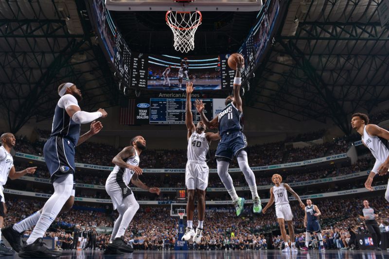 DALLAS, TX - OCTOBER 24: Kyrie Irving #11 of the Dallas Mavericks drives to the basket during the game against the San Antonio Spurs on October 24, 2024 at the American Airlines Center in Dallas, Texas. NOTE TO USER: User expressly acknowledges and agrees that, by downloading and or using this photograph, User is consenting to the terms and conditions of the Getty Images License Agreement. Mandatory Copyright Notice: Copyright 2024 NBAE (Photo by Glenn James/NBAE via Getty Images)