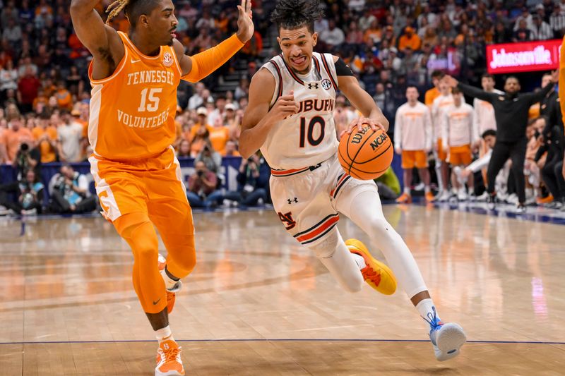 Mar 15, 2025; Nashville, TN, USA;  Auburn Tigers guard Chad Baker-Mazara (10) dribbles past Tennessee Volunteers guard Jahmai Mashack (15) during the second half at Bridgestone Arena. Mandatory Credit: Steve Roberts-Imagn Images