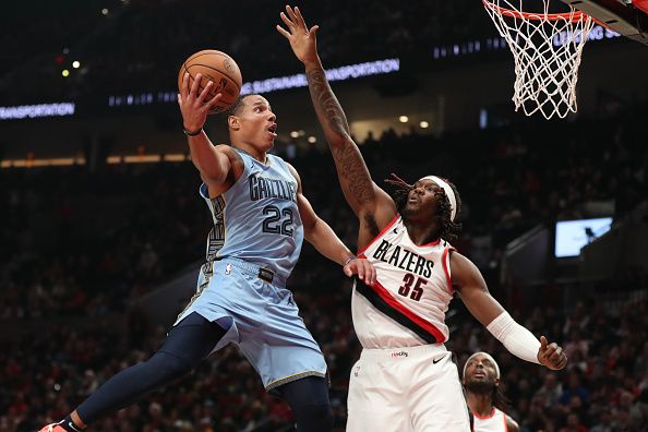 PORTLAND, OREGON - NOVEMBER 05: Desmond Bane #22 of the Memphis Grizzlies drives to the basket as Robert Williams III #35 of the Portland Trail Blazers defends during the first quarter at Moda Center on November 05, 2023 in Portland, Oregon. NOTE TO USER: User expressly acknowledges and agrees that, by downloading and or using this photograph, User is consenting to the terms and conditions of the Getty Images License Agreement.? (Photo by Amanda Loman/Getty Images)