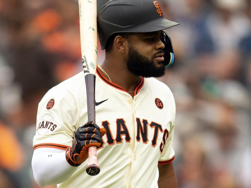 Jul 27, 2024; San Francisco, California, USA; San Francisco Giants center fielder Heliot Ramos (17) smacks himself in the helmet after striking out against the Colorado Rockies during the fifth inning at Oracle Park. Mandatory Credit: D. Ross Cameron-USA TODAY Sports