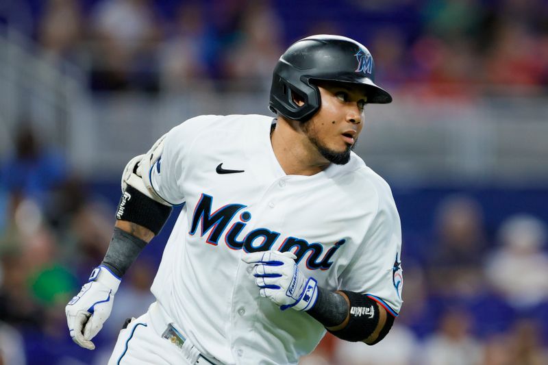 Jun 21, 2023; Miami, Florida, USA; Miami Marlins second baseman Luis Arraez (3) runs toward first base after hitting a single against the Toronto Blue Jays during the second inning at loanDepot Park. Mandatory Credit: Sam Navarro-USA TODAY Sports