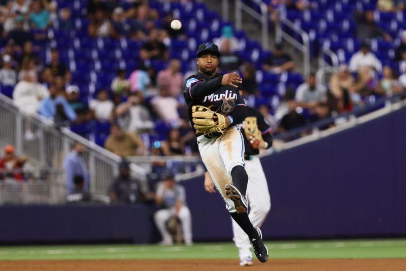 Jul 19, 2024; Miami, Florida, USA; Miami Marlins shortstop Xavier Edwards (63) throws to first base but cannot retire New York Mets catcher Francisco Alvarez (not pictured) during the fourth inning at loanDepot Park. Mandatory Credit: Sam Navarro-USA TODAY Sports