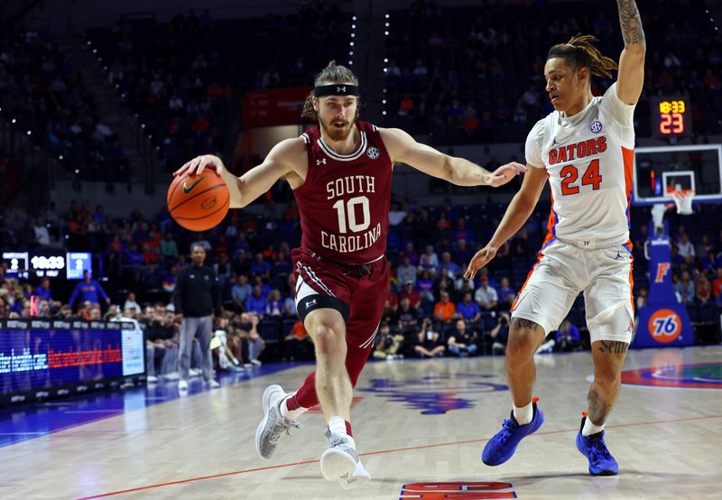 Jan 25, 2023; Gainesville, Florida, USA; South Carolina Gamecocks guard Jacobi Wright (1) drives to the basket as Florida Gators guard Riley Kugel (24) defends during the first half at Exactech Arena at the Stephen C. O'Connell Center. Mandatory Credit: Kim Klement-USA TODAY Sports