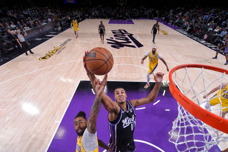 SACRAMENTO, CA - MARCH 13:  De'Aaron Fox #5 of the Sacramento Kings and D'Angelo Russell #1 of the Los Angeles Lakers battle for a rebound on March 13, 2024 at Golden 1 Center in Sacramento, California. NOTE TO USER: User expressly acknowledges and agrees that, by downloading and or using this Photograph, user is consenting to the terms and conditions of the Getty Images License Agreement. Mandatory Copyright Notice: Copyright 2024 NBAE (Photo by Rocky Widner/NBAE via Getty Images)