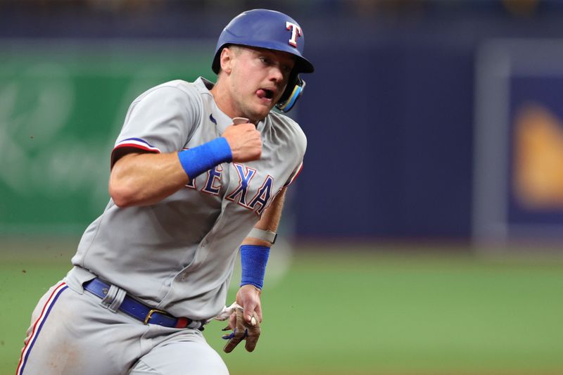 Oct 4, 2023; St. Petersburg, Florida, USA; Texas Rangers third baseman Josh Jung (6) runs around third base and scores a run against the Tampa Bay Rays in the sixth inning during game two of the Wildcard series for the 2023 MLB playoffs at Tropicana Field. Mandatory Credit: Nathan Ray Seebeck-USA TODAY Sports