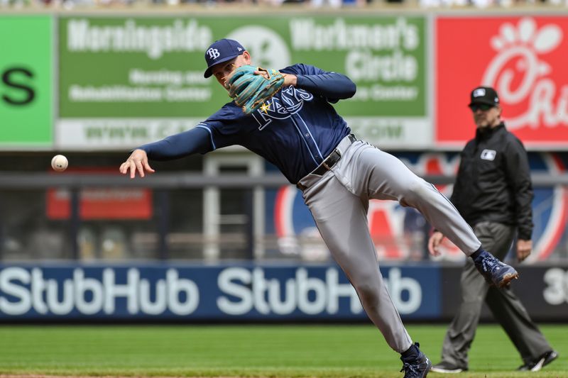 Apr 20, 2024; Bronx, New York, USA; Tampa Bay Rays second base Curtis Mead (25) fields a ground ball and throws to first base for an out during the first inning against the New York Yankees at Yankee Stadium. Mandatory Credit: John Jones-USA TODAY Sports