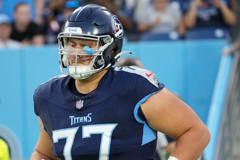 Tennessee Titans offensive lineman Peter Skoronski (77) runs onto the field before an NFL preseason football game against the New England Patriots, Friday, Aug. 25, 2023, in Nashville, Tenn. (AP Photo/George Walker IV)