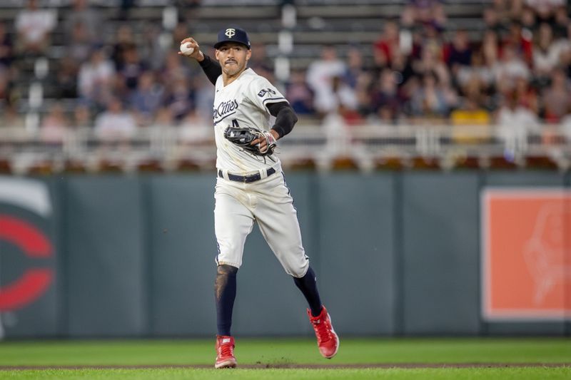 May 10, 2023; Minneapolis, Minnesota, USA; Minnesota Twins shortstop Carlos Correa (4) throws the ball to first base for an out in the tenth inning against the San Diego Padres at Target Field. Mandatory Credit: Jesse Johnson-USA TODAY Sports