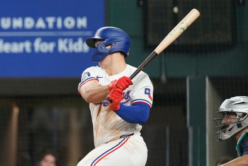 Apr 24, 2024; Arlington, Texas, USA; Texas Rangers designated hitter Wyatt Langford (36) follows through on his single against the Seattle Mariners during the sixth inning at Globe Life Field. Mandatory Credit: Jim Cowsert-USA TODAY Sports