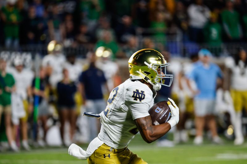 Sep 30, 2023; Durham, North Carolina, USA; Notre Dame Fighting Irish running back Devyn Ford (22) runs with the ball during the first half of the game against Duke Blue Devils at Wallace Wade Stadium. Mandatory Credit: Jaylynn Nash-USA TODAY Sports