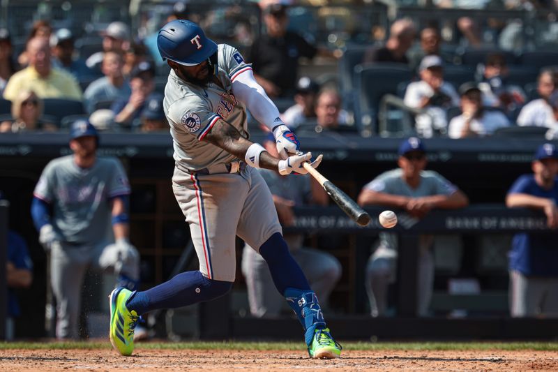 Aug 11, 2024; Bronx, New York, USA; Texas Rangers outfielder Adolis Garcia (53) singles during the seventh inning against the New York Yankees at Yankee Stadium. Mandatory Credit: Vincent Carchietta-USA TODAY Sports