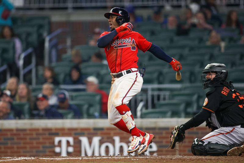 May 5, 2023; Atlanta, Georgia, USA; Atlanta Braves second baseman Ozzie Albies (1) hits a single against the Baltimore Orioles in the eighth inning at Truist Park. Mandatory Credit: Brett Davis-USA TODAY Sports